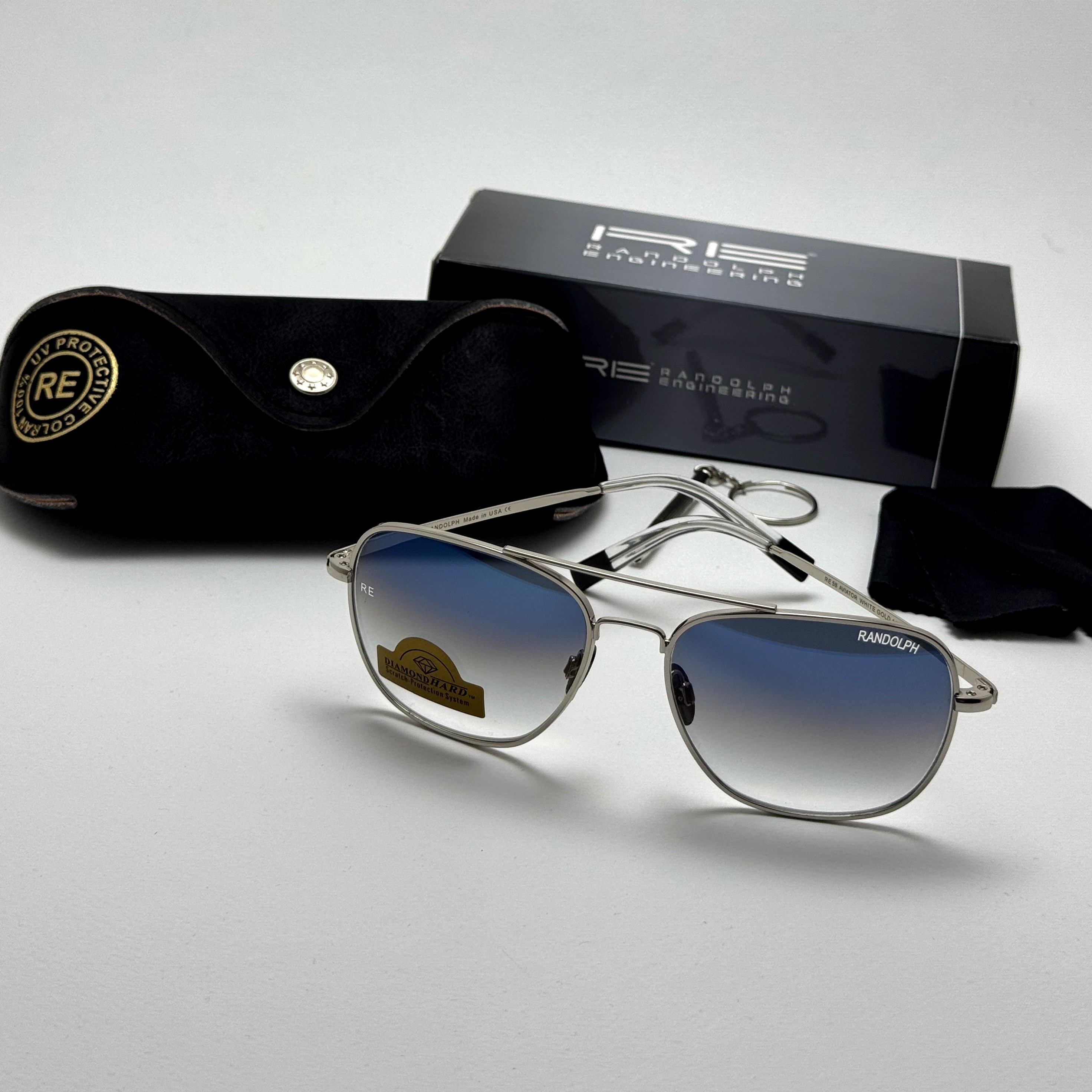 عینک آفتابی خلبانی رندولف شیشه سنگ آنتی رفلکس آبی هایلایت نقره ای فول پک RANDOLPH AVIATOR RE 58 24K WHITE GOLD